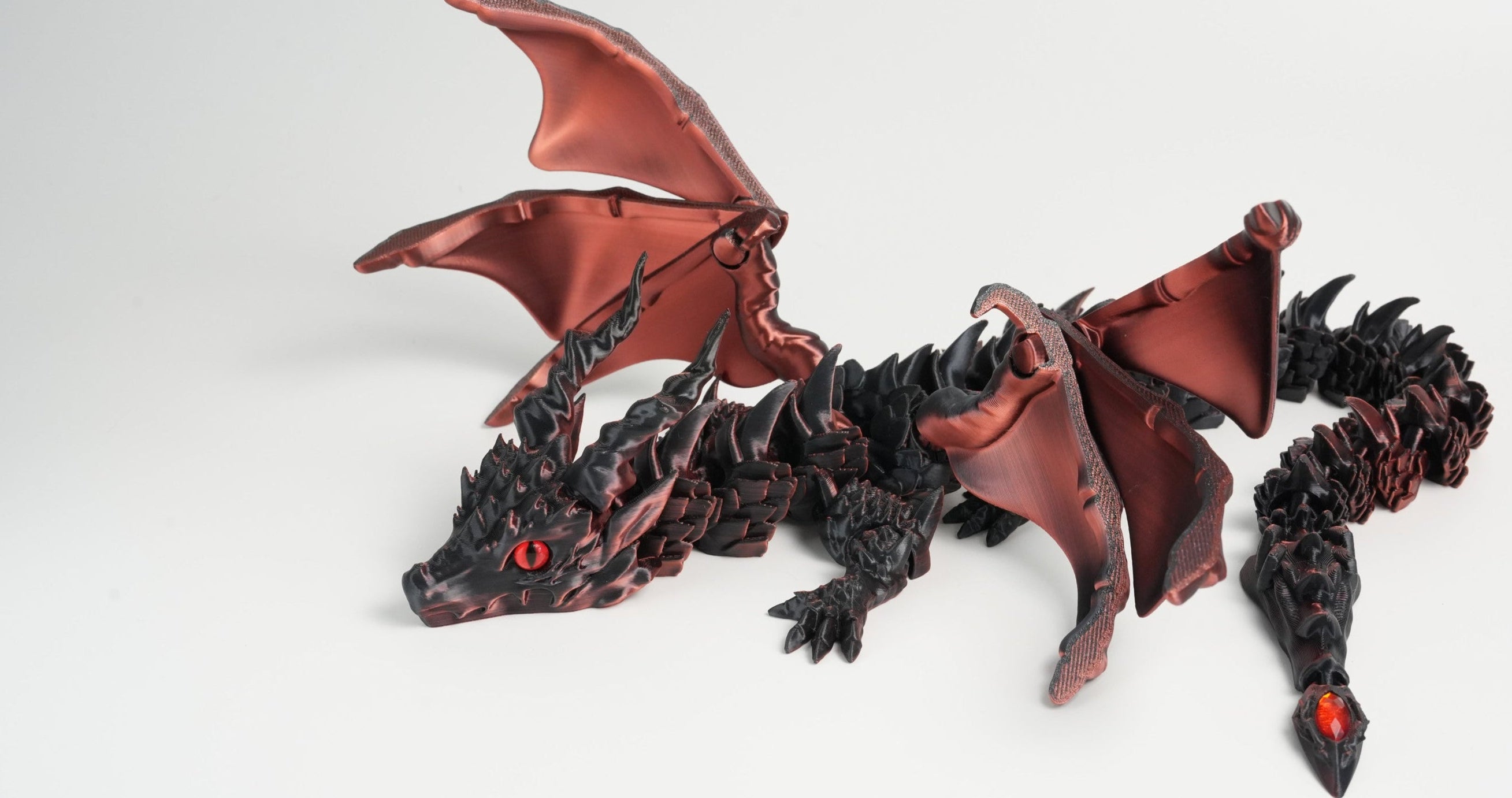 Dragon figurine with red accents on a white background