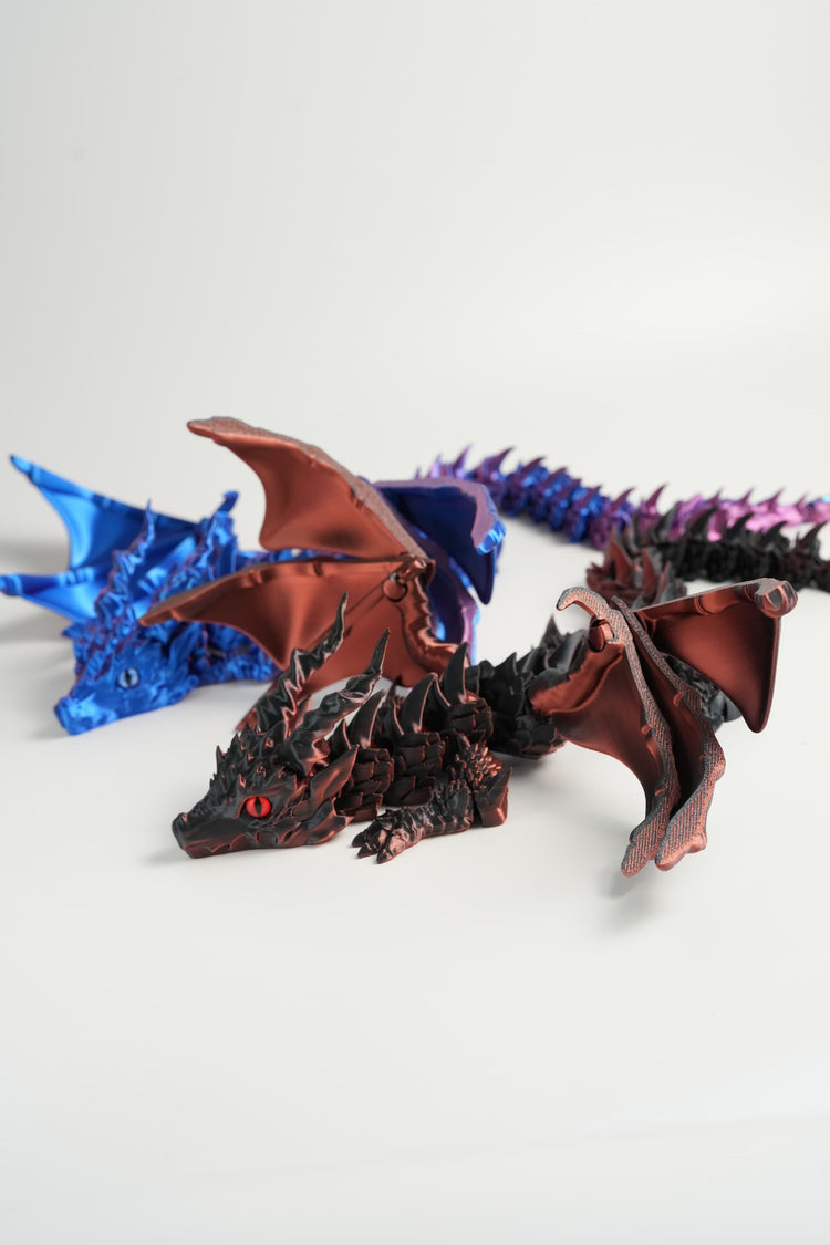 Dragon figurine with blue and purple scales on a white background
